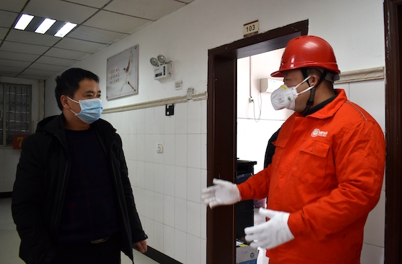 2月4日，国网重庆城口供电公司党员赵安刚（右一）在沿河乡政府了解抗疫阶段用电需求 受访者供图.jpg