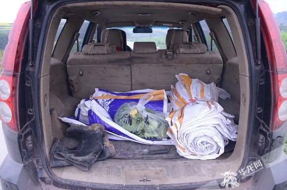 肖春华的汽车后备箱里随时放着绳子,刀,口袋.记者 陈星 摄